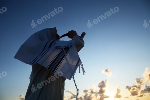 Preview: Jewish man blowing the Shofar horn of Rosh Hashanah - New Year. Sunrise Shofar