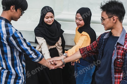 Preview: Group of asian friends doing team hand shake