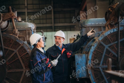 Preview: Engineer are working in the factory. Worker helping to repair and inspect the machine's readiness.