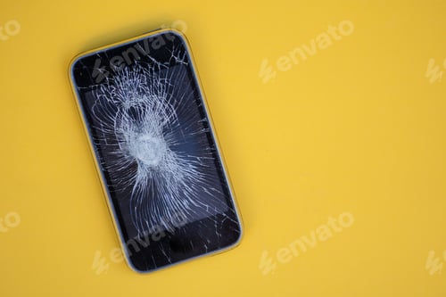 Preview: Cracked screen on mobile phone against colorful background