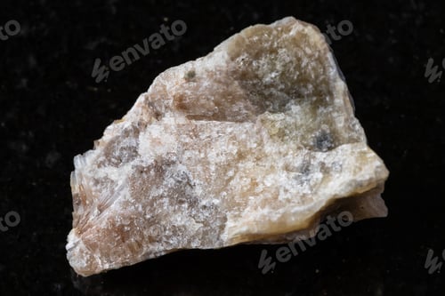 Preview: sample of raw cancrinite rock on black granite