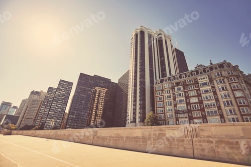 Preview: Retro toned photo of Chicago city downtown against the sun, USA
