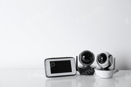 Preview: Modern CCTV security cameras and monitor on white background. Space for text