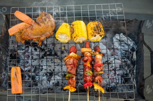 Preview: delicious grilled meat with smoke, BBQ with vegetables in outdoor. Barbecue, Party and picnic