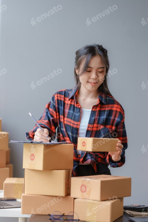 Preview: E-commerce Entrepreneurship. Asian Female Online Seller Packing Orders for Internet Sales