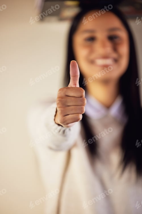 Preview: I love being a college student. Cropped shot of a young woman showing thumbs up.