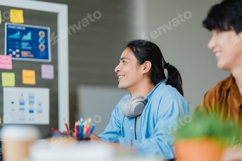 Preview: Asian businessmen and businesswomen meeting brainstorming in small office.