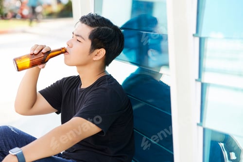 Preview: Young man with beer outdoors