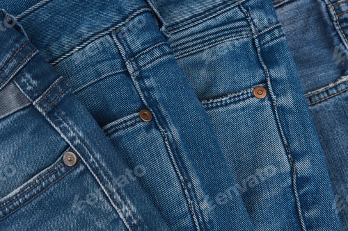 Preview: Stack Of Various Shades Of Blue Jeans On White Background Denim Jeans Texture. Denim Background