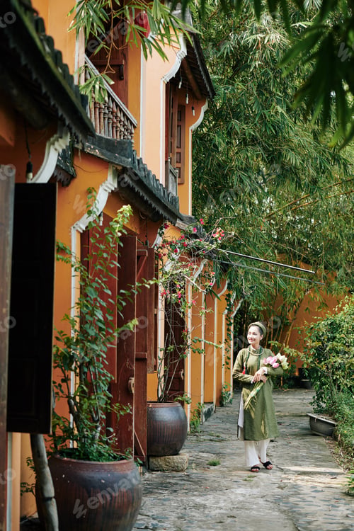 Preview: Woman walking with lotus flowers