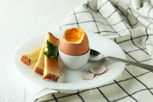 Preview: Concept of tasty breakfast with boiled egg on white textured table