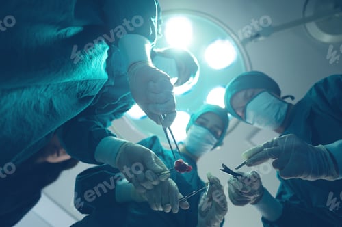 Preview: Medical team of surgeons in hospital doing invasive surgical interventions