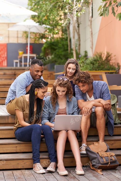 Students Gather and Work on a Laptop Outside