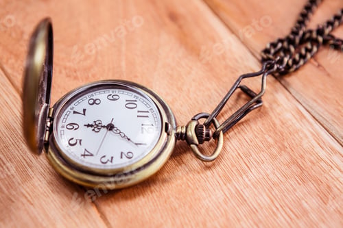 Preview: Close up view of a pocket watch on wooden desk