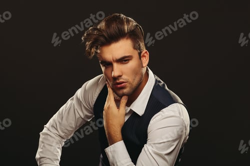 Preview: Portrait od handsome man in studio on dark background