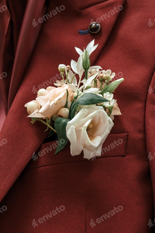 Preview: Groom's boutonniere on a maroon suit.