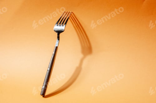 Preview: Front view of kitchen cutlery set leaning against the wall on golden background with free space