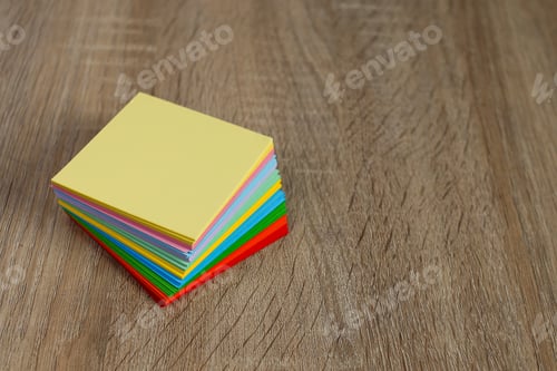 Preview: Stack Of Colorful Sticky Notes Neatly Arranged On Textured Wooden Floor
