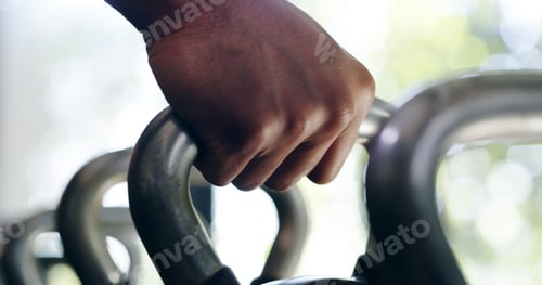 Preview: Person, hand and kettlebell in gym for fitness, bodybuilding and arm muscle development. Closeup, m