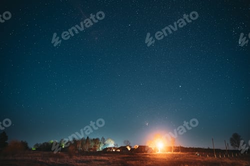 Preview: Real Night Sky Stars Above Old Village. Natural Starry Sky Above Rural Landscape In Belarus