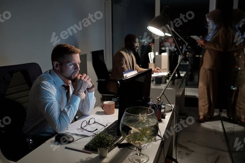 Preview: Contemporary businessman and his coworkers staying in office at night