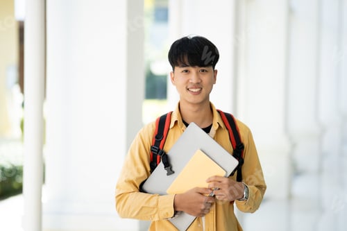 Preview: Smiling College Student Holding Books in School Corridor