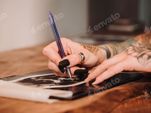 Preview: Tattoo artist drawing illustration inside ink studio