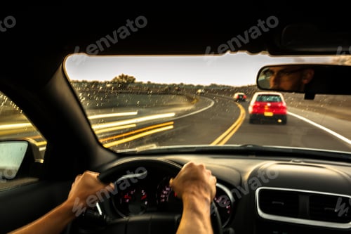 Preview: Mid adult man driving car at speed