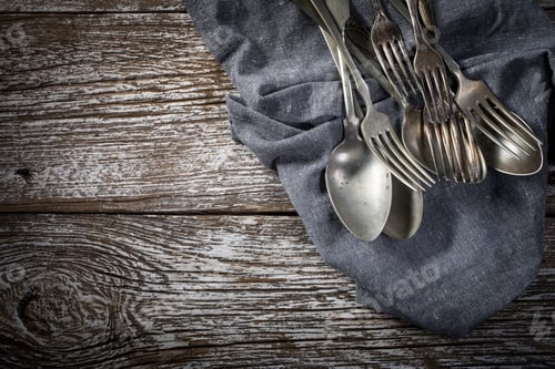 A few old silver spoons and forks.