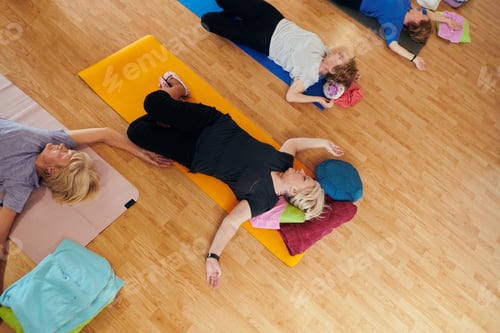 Preview: A group of senior women engage in various yoga exercises, including neck, back, and leg stretches