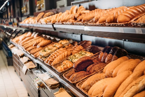 Preview: selective focus of freshly baked bread in pastry department of grocery shop