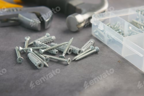 Preview: A Varied Selection of Screws and Handy Tools Displayed on a Work Surface Ready for Use