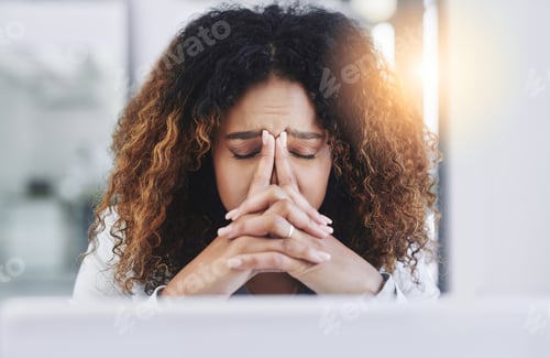 Preview: Shot of a young businesswoman looking stressed out in an office