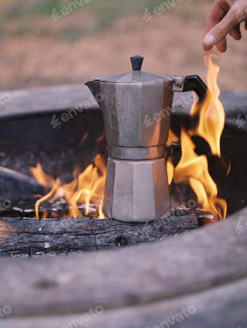 Preview: Espresso maker standing over an outdoor fire.