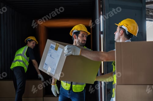 Preview: Worker carry carton box taken from 40 feet steel container on the trailer truck park at warehouse