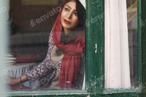 Preview: She smiles through an old window