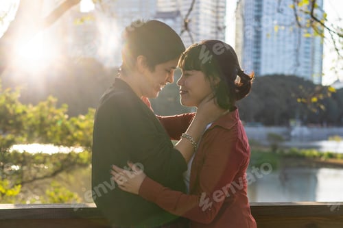 Preview: Young LGBT couple of women sharing a warm embrace while looking into each other's eyes at sunset