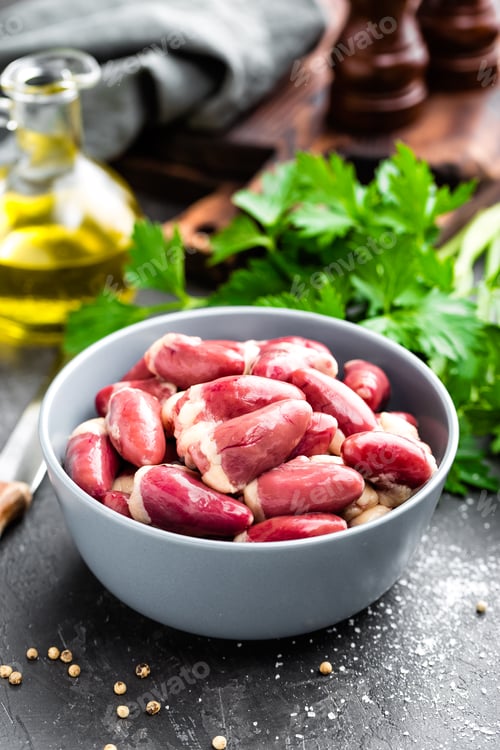 Preview: Fresh raw chicken hearts on dark background