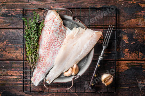 Preview: Raw red perch fillet, redfish fish meat in a steel tray. Wooden background. Top view