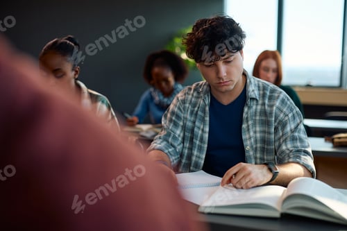 Preview: College student learning while attending a lecture in the classroom.