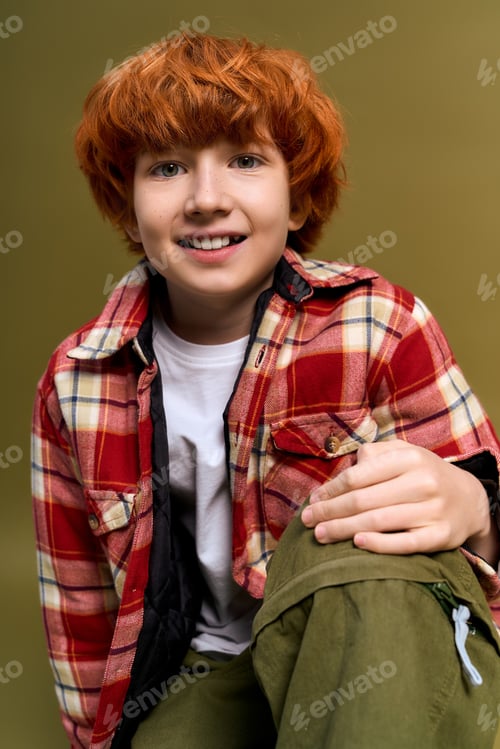 Preview: Little boy showcases fashionable style with confidence and charm in a playful setting