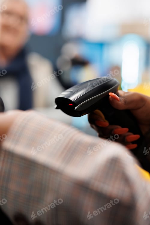 Preview: African american employee scanning elegant blouse