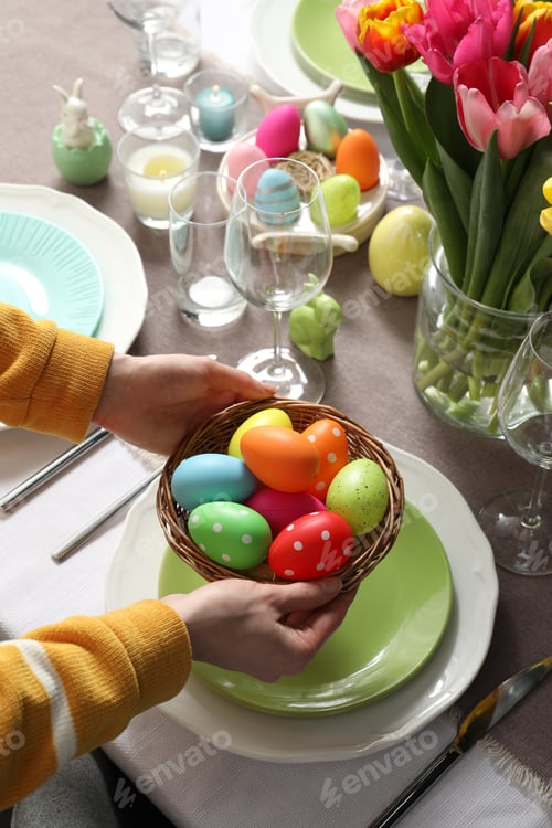 Preview: Woman setting table for festive Easter dinner at home, closeup