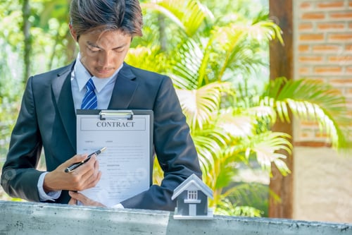 Preview: Real estate agent holding home model and explain the business contract, rent or insurance