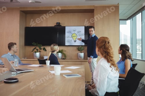 Preview: Businessman explaining plans to colleagues