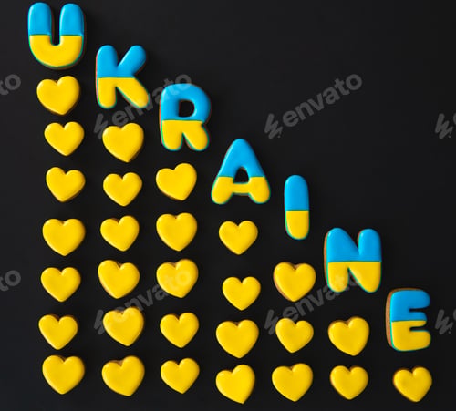 Preview: The word Ukraine on a black background, made with handmade gingerbread.