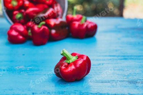 Preview: Fresh colorful bell pepper box on wooden table.