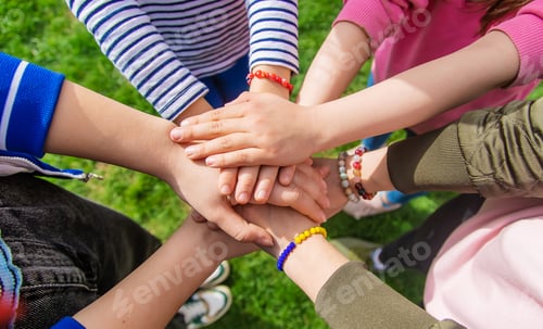 Preview: People put their hands together. Selective focus.