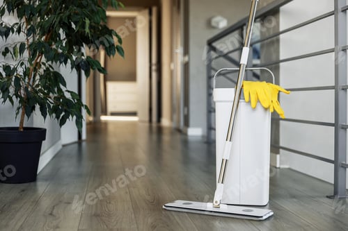 Preview: Cleaning supplies: mop, gloves, bucket with wringer on wooden laminate floor