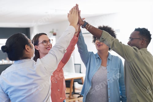 Preview: Shot of a group of young businesspeople joining hands in solidarity in a modern office
